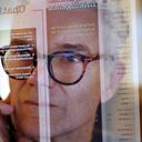 Close up stock photograph of a mature man studying a see-through computer monitor that’s displaying text provided by an AI (artificial intelligence) chatbot.