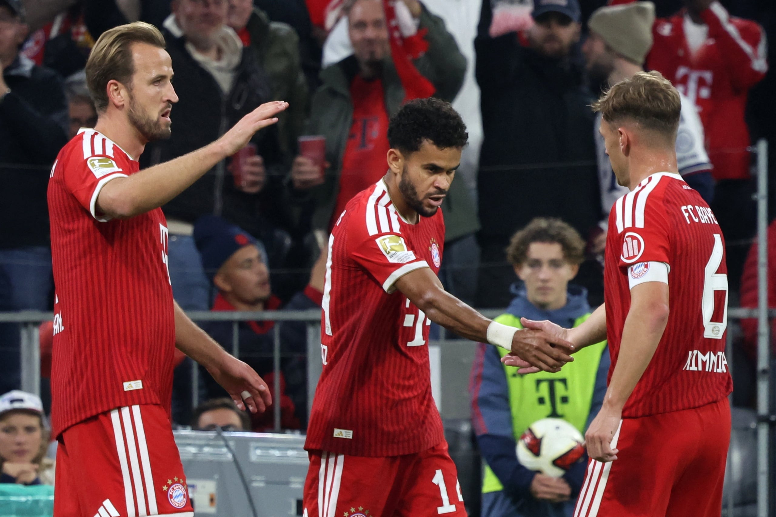 Bayern's Luis Díaz, centre, celebrates with teammates Harry Kane, left, and Joshua Kimmich, after scoring his side's first goal of the game during the Bundesliga soccer match between Bayern Munich and Leipzig, in Munich, Germany, Saturday Oct. 17, 2026. (Karl-Josef Hildenbrand/dpa via AP)