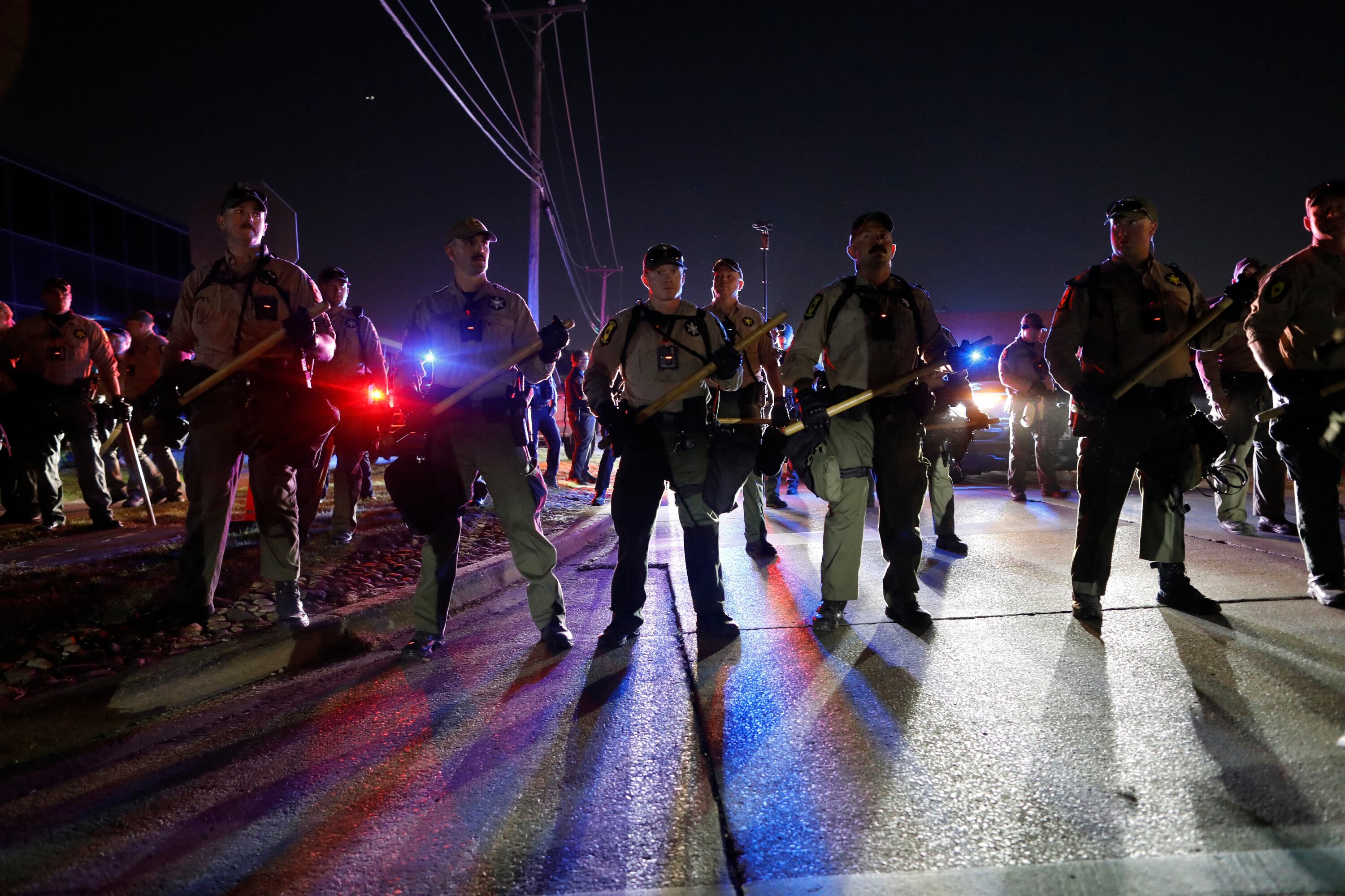 Illinois State Police stand guard while monitoring protesters gathering near an Immigration and Customs Enforcement (ICE) facility in Broadview, Illinois, on October 4, 2025. US President Donald Trump, who campaigned on a pledge to deport large numbers of migrants, has encouraged authorities to be more aggressive as he seeks to hit his widely reported target of one million deportations annually. (Photo by OCTAVIO JONES / AFP)