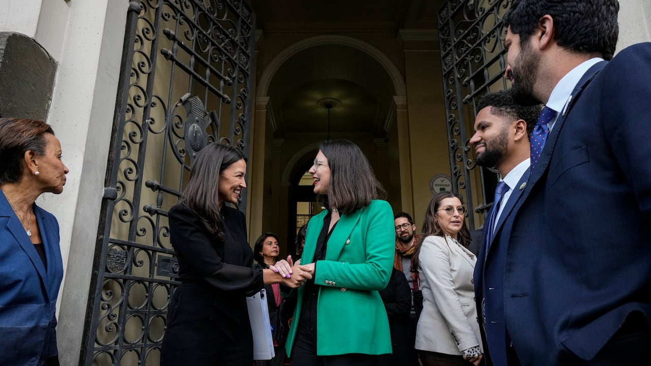 La congresista Alexandria Ocasio-Cortez, (D-NY), centro izquierda, le da la mano al alcalde Iraci Hassler, en Santiago, Chile, el jueves 17 de agosto de 2023. Ocasio-Cortez es parte de una delegación estadounidense que viajó a Chile para conocer los esfuerzos por defender su democracia de cara al 50 aniversario del golpe militar liderado por el Gral. Augusto Pinochet. (Foto AP/Esteban Félix)