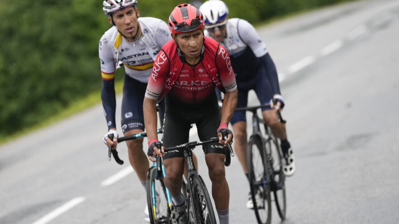Colombia's Nairo Quintana, center, Spain's Omar Fraile, left, and Michael Woods of Canada climb Col des Saisies pass during the ninth stage of the Tour de France cycling race over 144.9 kilometers (90 miles) with start in Cluses and finish in Tignes, France, Sunday, July 4, 2021. (AP Photo/Daniel Cole)