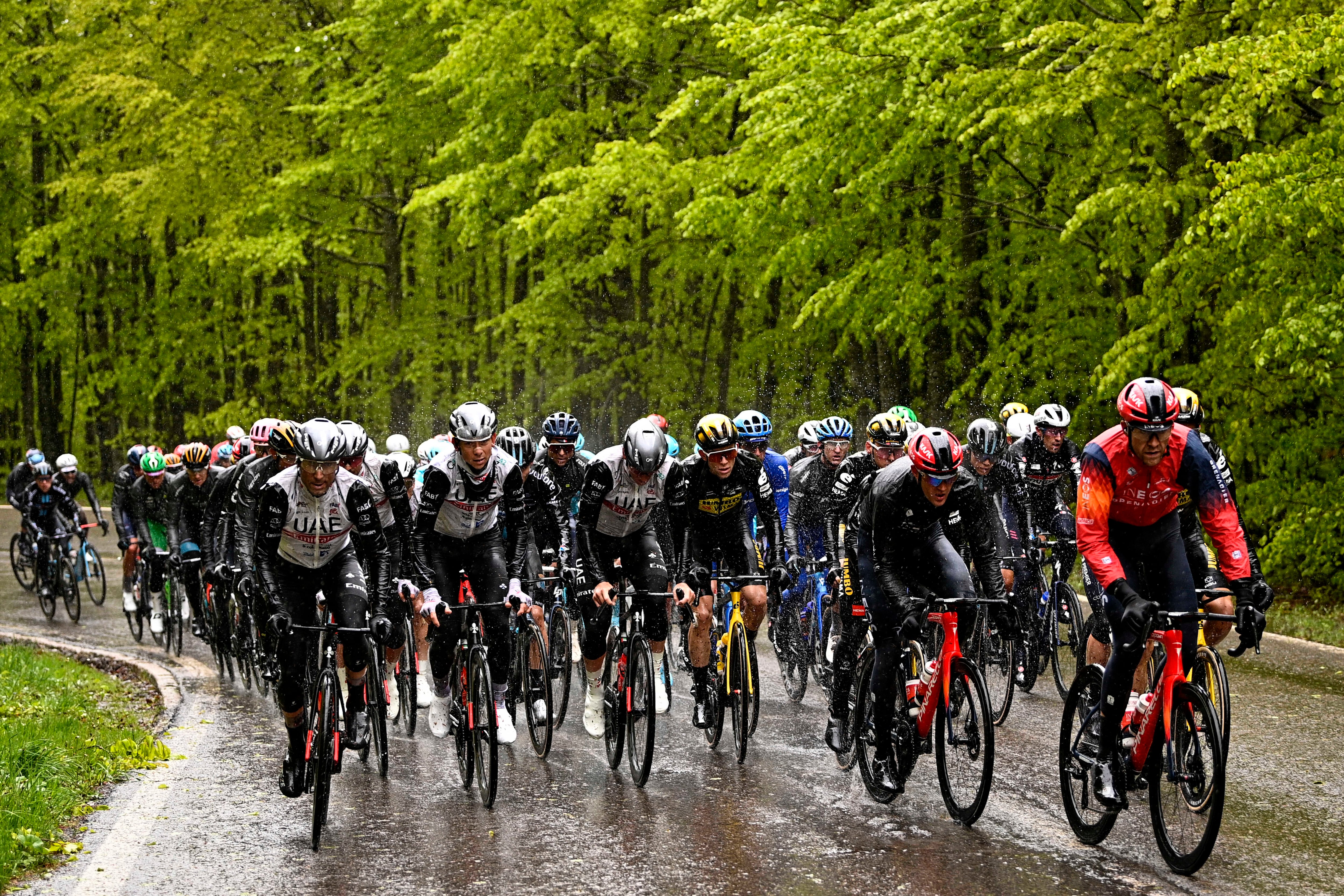 The pack of cyclists pedals under the rain during the 10th stage of the Giro D'Italia, tour of Italy cycling race, from Scandiano to Viareggio, Italy, Tuesday, May 16, 2023. (Fabio Ferrari/LaPresse via AP)