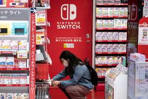 A customer browses the gaming section of Nintendo products in a shop in Tokyo on May 6, 2021. (Photo by Philip FONG / AFP)