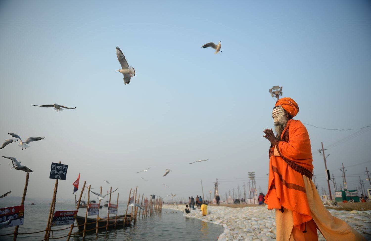 Un sadhu indio realiza la oración de la tarde en Sangam durante el festival de Magh Mela en Allahabad el 9 de enero de 2018. El Magh Mela se celebra todos los años en las orillas de Triveni Sangam, la confluencia de los tres grandes ríos Ganga, Yamuna y el místico Saraswati. AFP PHOTO / SANJAY KANOJIA.
