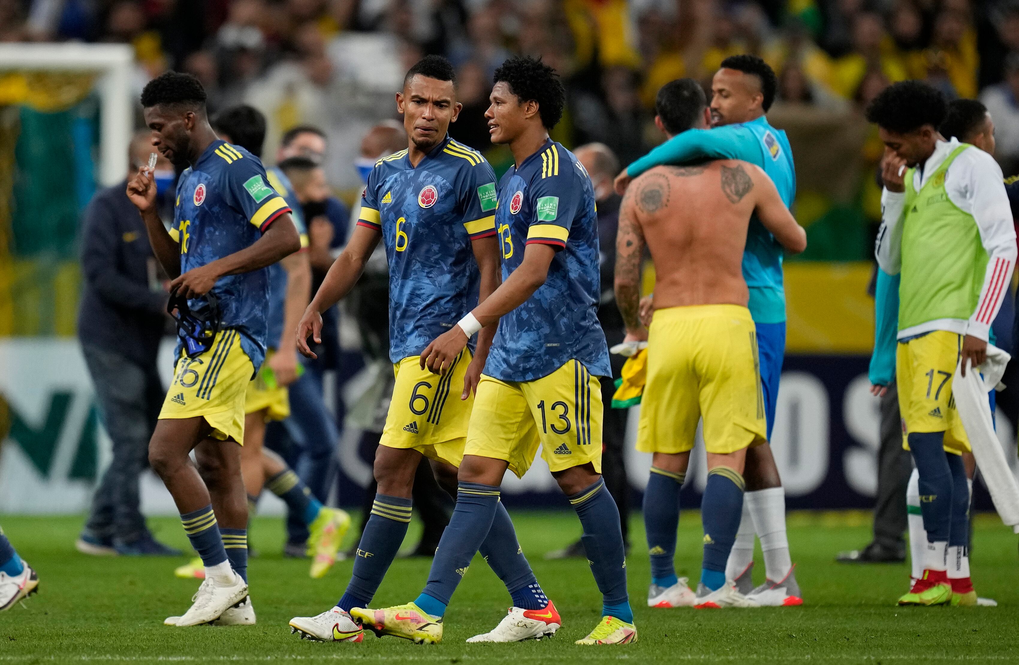 Players of Colombia leave the field after losing 1-0 against Brazil at the end of a qualifying soccer match for the FIFA World Cup Qatar 2022 at Neo Quimica Arena stadium in Sao Paulo, Brazil, Thursday, Nov.11, 2021. (AP Photo/Andre Penner)