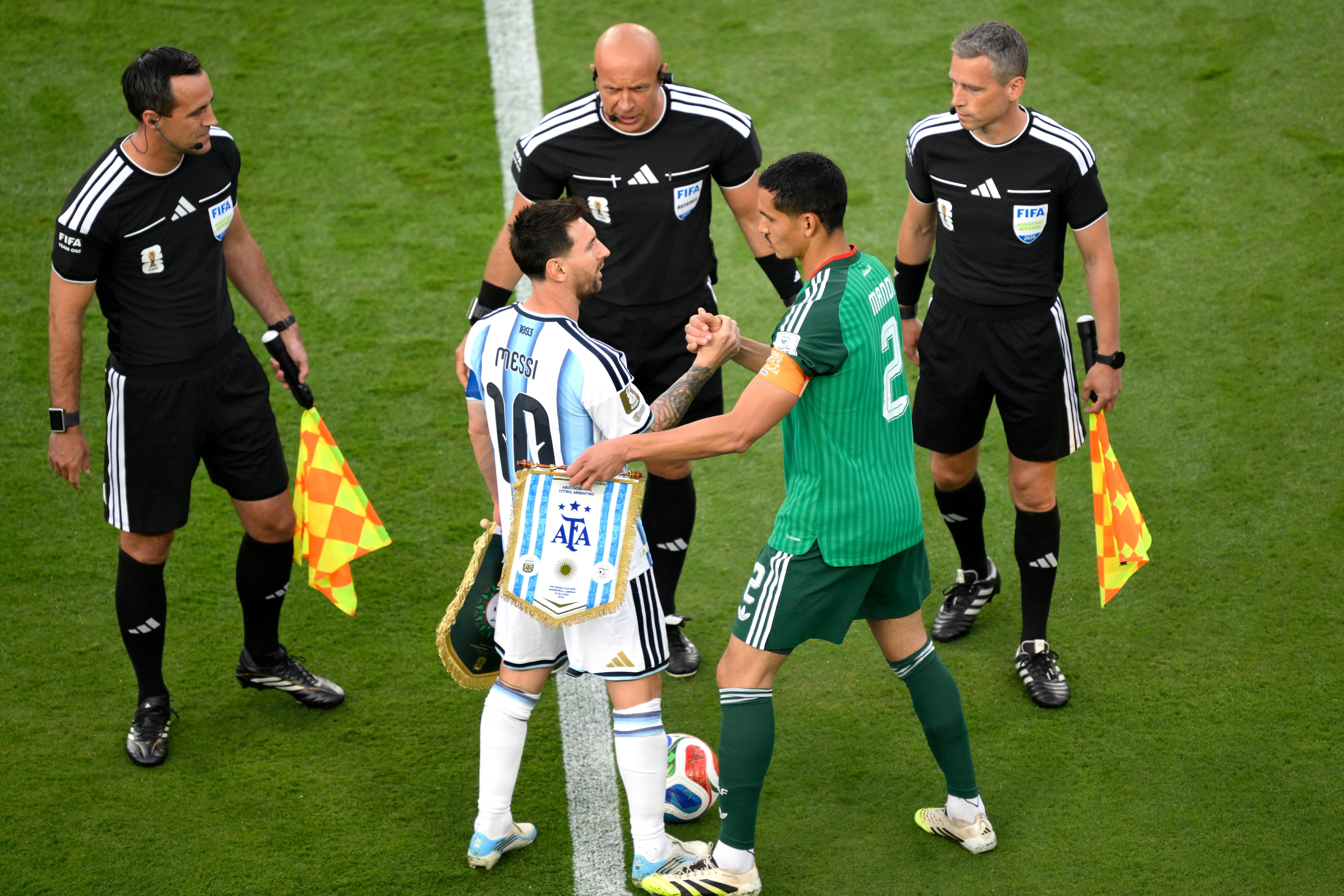 Argentina's Lionel Messi (10) and Algeria's Aissa Mandi (2) shake hands before the World Cup Group J soccer match between Argentina and Algeria in Kansas City, Mo., Tuesday, June 16, 2026. (AP Photo/Reed Hoffmann)