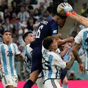 El arquero argentino Emiliano Martínez, a la derecha, detiene un cabezazo del croata Dejan Lovren durante el partido de fútbol de semifinales de la Copa del Mundo entre Argentina y Croacia en el Estadio Lusail en Lusail, Qatar, el martes 13 de diciembre de 2022.