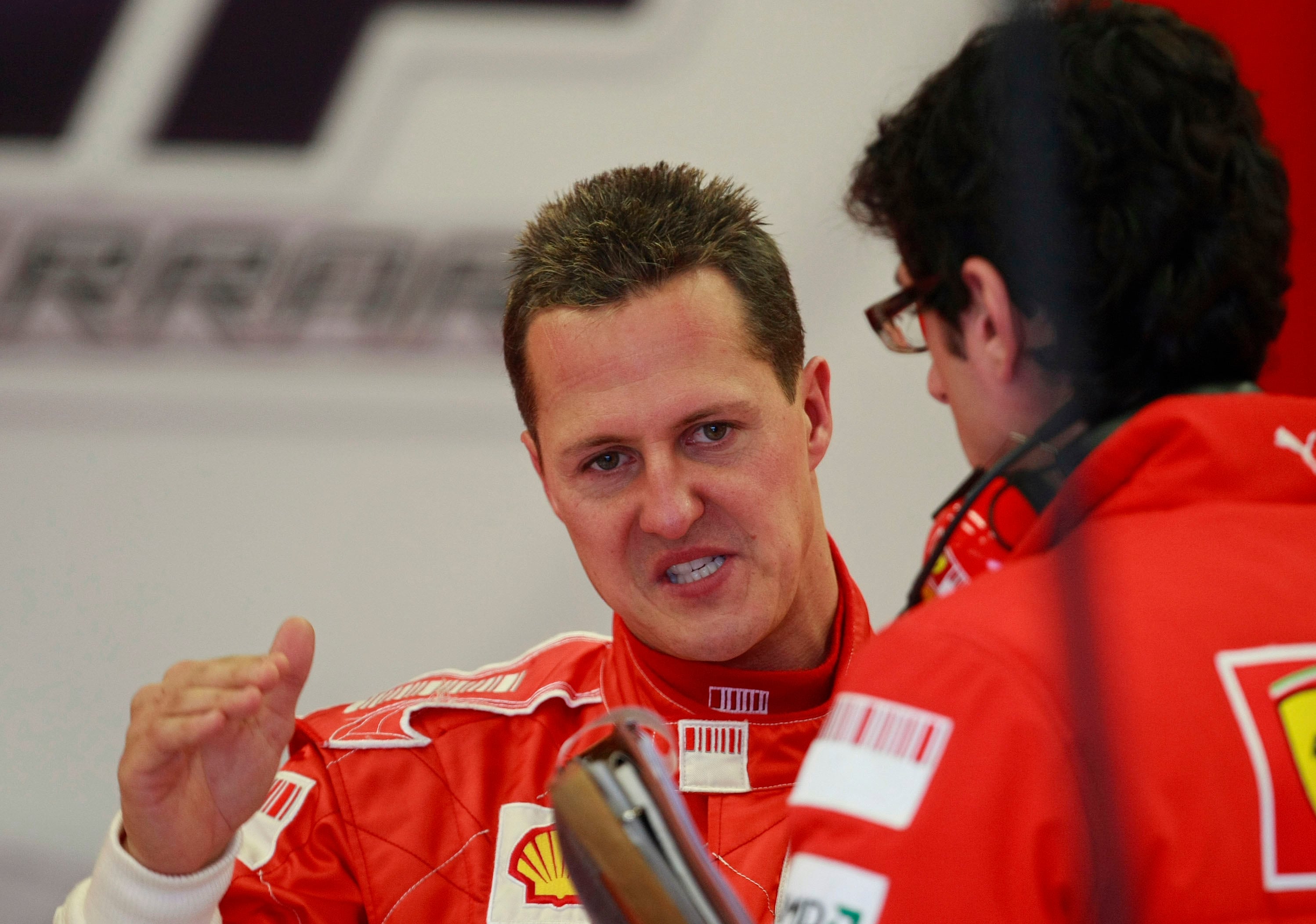 JEREZ DE LA FRONTERA, SPAIN - DECEMBER 07:  Seven times world champion Michael Schumacher of Germany chats with a Ferrari mechanic while testing in  Formula One Testing at the Circuito de Jerez on December 7, 2007 in Jerez de la Frontera, Spain. (Photo by Denis Doyle/Getty Images)