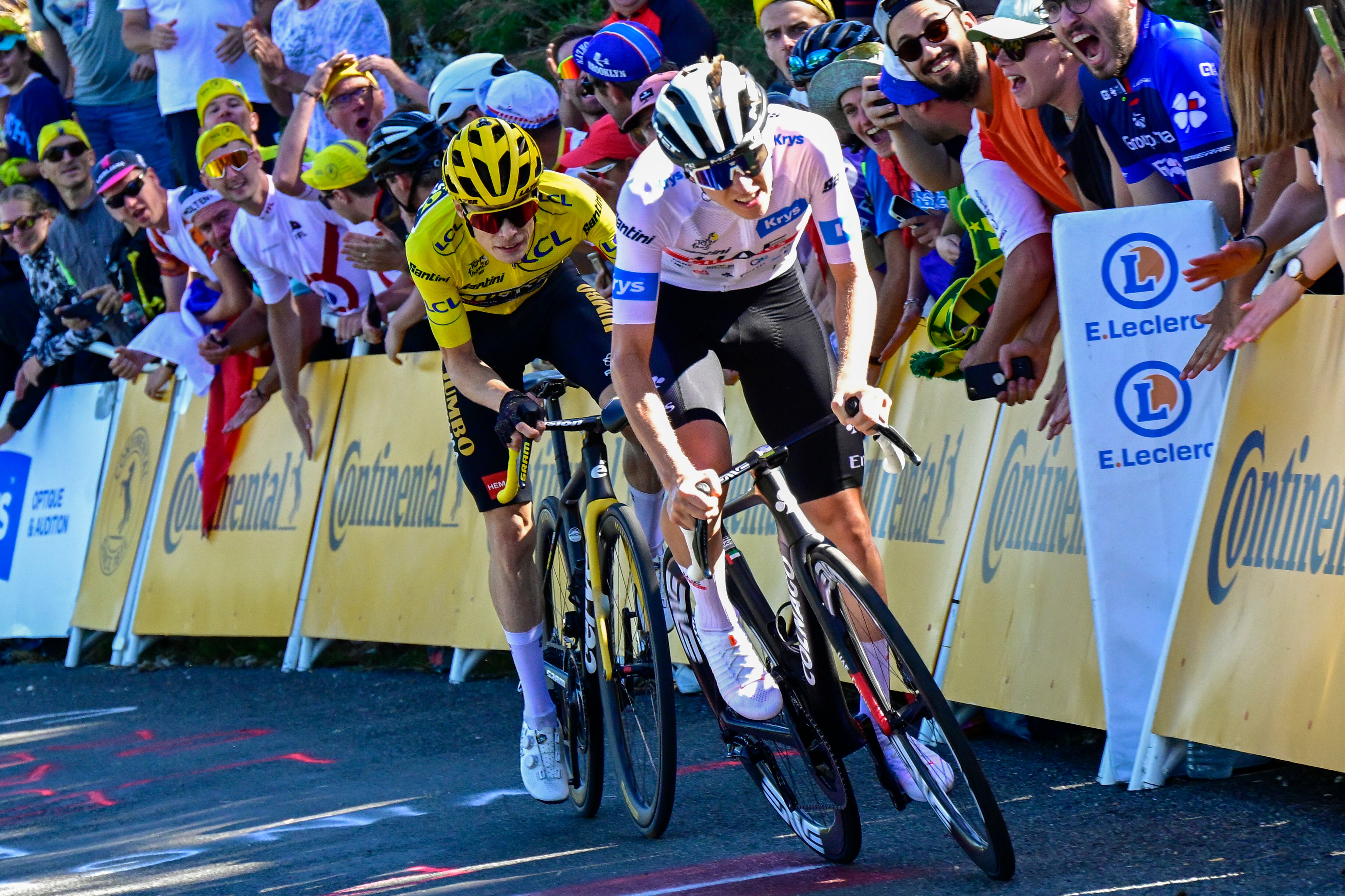 Slovenia's Tadej Pogacar, wearing the best young rider's white jersey, tries to break away from Denmark's Jonas Vingegaard, wearing the overall leader's yellow jersey, during the thirteenth stage of the Tour de France cycling race over 138 kilometers (86 miles) with start in Chatillon-sur-Chalaronne and finish on Grand Colombier pass, France, Friday, July 14, 2023. (Bernard Papon/Pool Photo via AP)