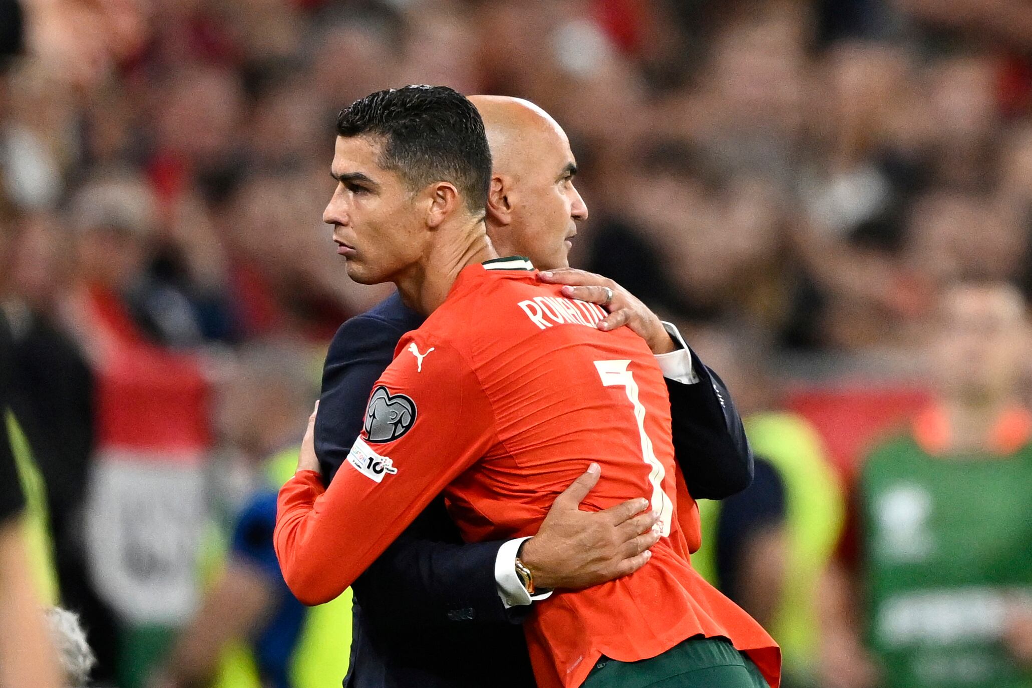 Portugal's Cristiano Ronaldo embraces Portugal coach Roberto Martinez after being substituted during a World Cup 2026 group F qualifying soccer match between Hungary and Portugal at the Puskas Arena in Budapest, Tuesday, Sept. 9, 2025. (AP Photo/Denes Erdos)
