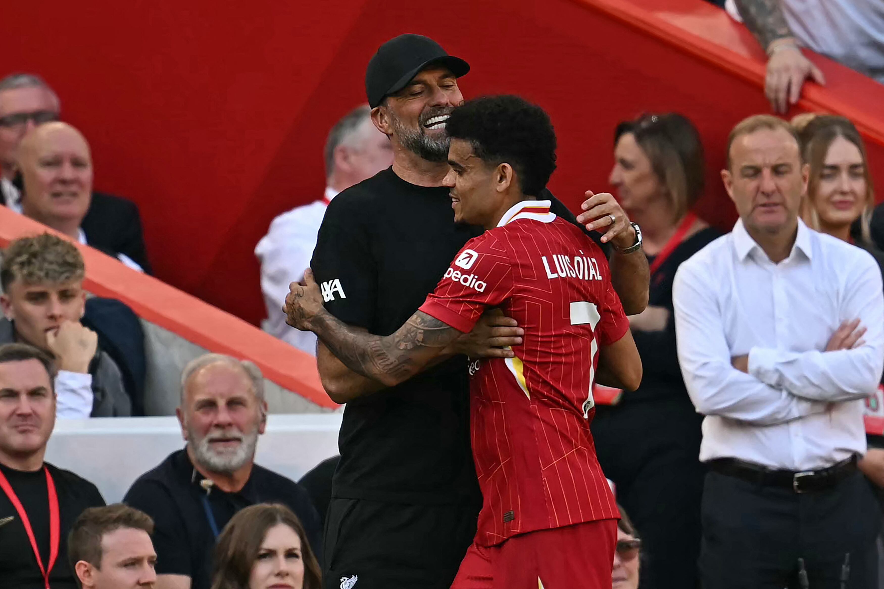 Liverpool's German manager Jurgen Klopp (L) embraces Liverpool's Colombian midfielder #07 Luis Diaz as he leaves the pitch substituted during the English Premier League football match between Liverpool and Wolverhampton Wanderers at Anfield in Liverpool, north west England on May 19, 2024. (Photo by Paul ELLIS / AFP) / RESTRICTED TO EDITORIAL USE. No use with unauthorized audio, video, data, fixture lists, club/league logos or 'live' services. Online in-match use limited to 120 images. An additional 40 images may be used in extra time. No video emulation. Social media in-match use limited to 120 images. An additional 40 images may be used in extra time. No use in betting publications, games or single club/league/player publications. /
