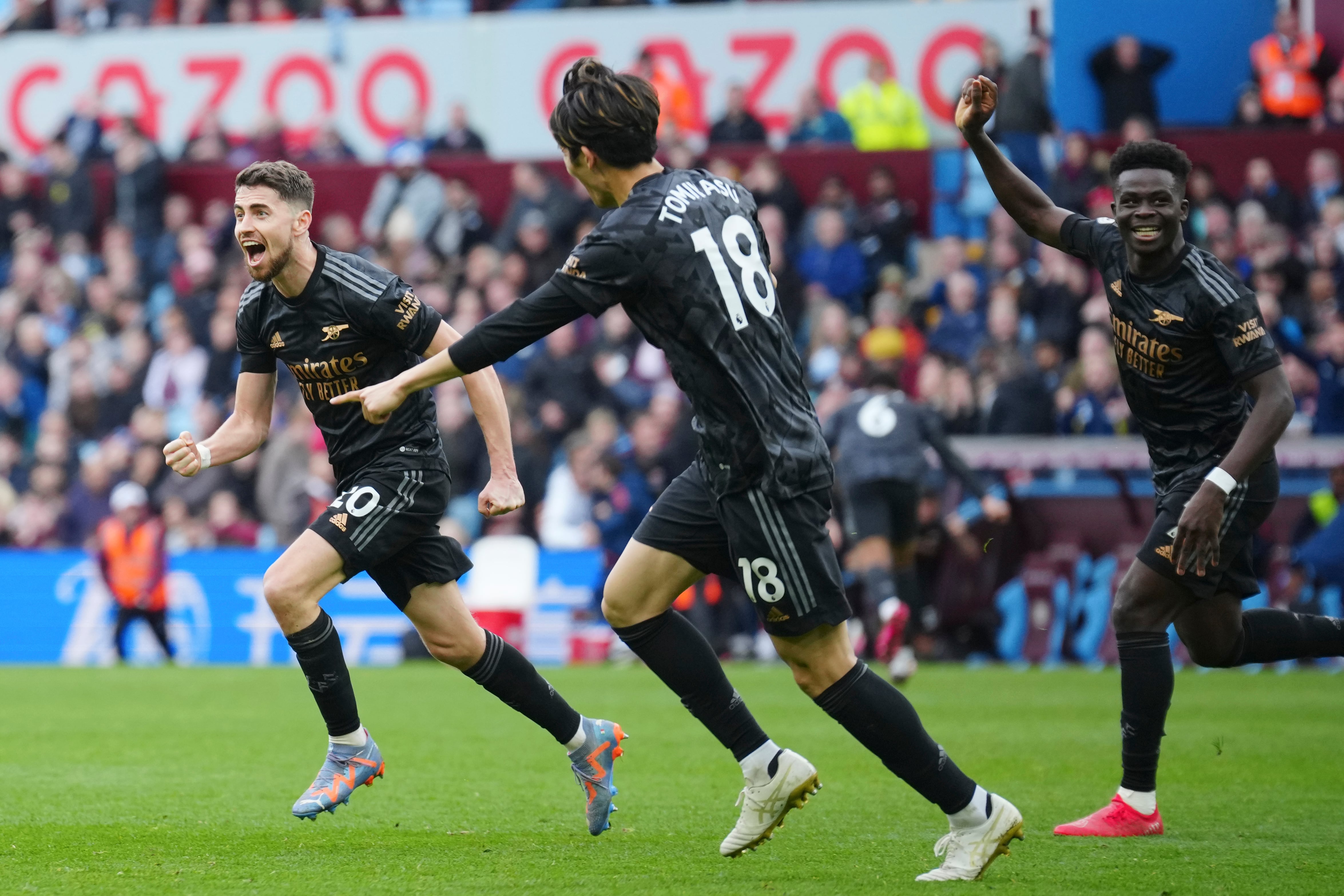Arsenal's Jorginho, left, celebrates after scoring during the English Premier League soccer match between Aston Villa and Arsenal at Villa Park in Birmingham, England, Saturday, Feb. 18, 2023. (AP Photo/Jon Super)