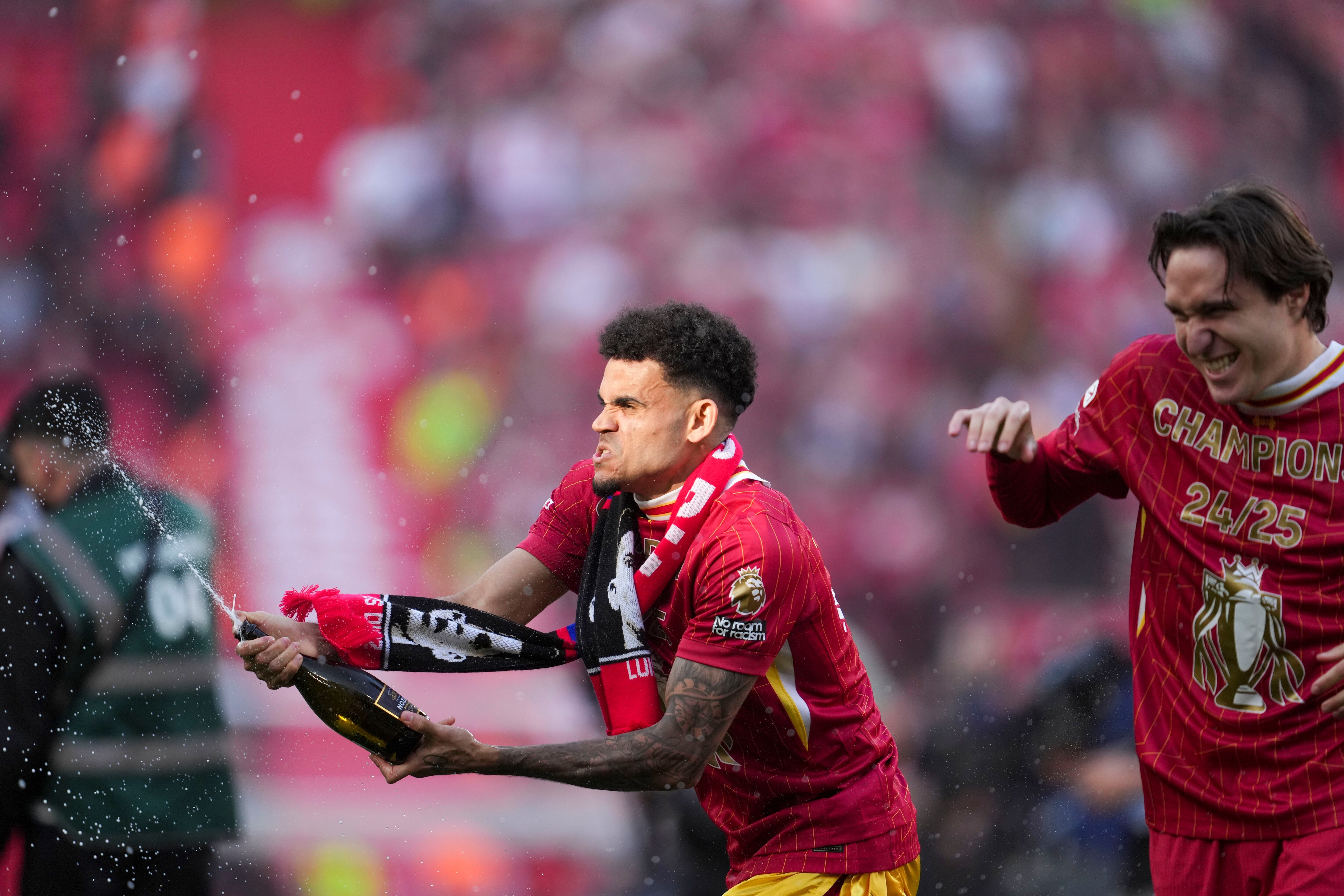 iverpool's Luis Diaz, left, and Liverpool's Federico Chiesa celebrate after winning the English Premier League soccer match between Liverpool and Tottenham Hotspur and clinching the Premier League title at Anfield in Liverpool, England, Sunday, April 27, 2025. (AP Photo/Jon Super)