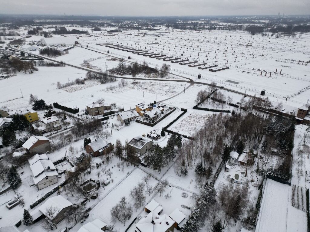 Los cuarteles del antiguo campo de concentración y exterminio nazi alemán Auschwitz 2 - Birkenau - ahora forman parte del Memorial y Museo Auschwitz-Birkenau, se ven sobre los edificios del pueblo de Brzezinka el 13 de enero de 2025. Auschwitz fue liberado hace 80 años el El 27 de enero se celebrará allí una ceremonia con decenas de supervivientes, entre los pocos que quedan. (Foto de Wojtek RADWANSKI / AFP)