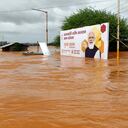 A billboard with a photograph of Prime Minister Narendra Modi is partially submerged in flood waters at Kolhapur in western Maharashtra state, India, Saturday, July 24, 2021. Officials say landslides and flooding triggered by heavy monsoon rain have killed more than 100 people in western India. More than 1,000 people trapped by floodwaters have been rescued. (AP Photo)