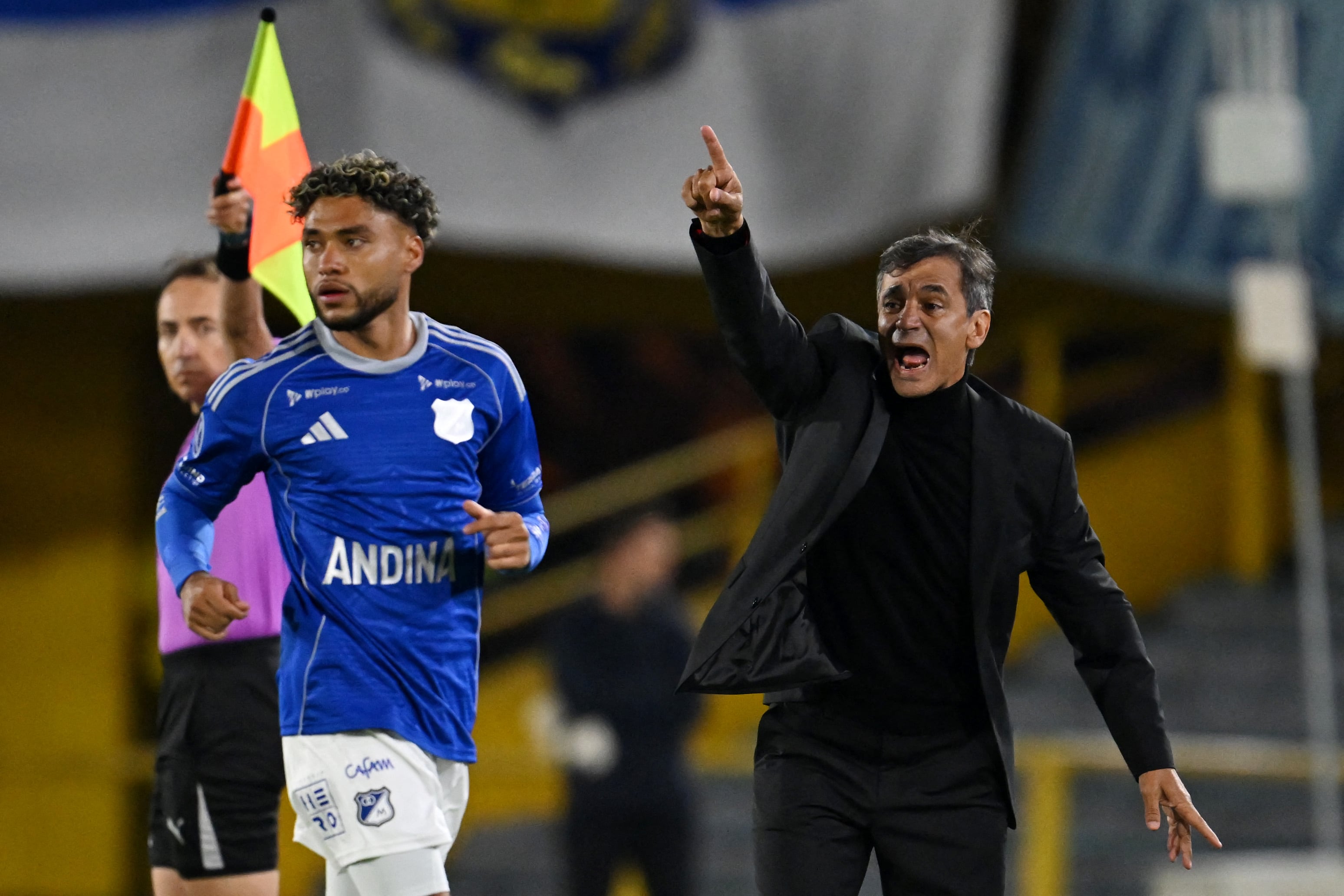 Millonarios' head coach Fabian Bustos gestures during the Copa Sudamericana group stage football match between Colombia's Millonarios and Uruguay's Boston River at the Nemesio Camacho El Campin Stadium in Bogota, on April 15, 2026. (Photo by Raul ARBOLEDA / AFP)