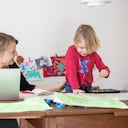 BERLIN, GERMANY - FEBRUARY 18: The photographer's son paints while his mother works and attends a digital conference at home in Zehlendorf district during the second wave of the coronavirus pandemic on February 18, 2021 in Berlin, Germany. The hard lockdown state governments launched in December, in which non-essential shops were closed and people's movements restricted in high-risk areas, has been continued into February. Some state authorities have indicated some easing might be possible soon as COVID-19 infection and death rates continue to fall. Meanwhile the vaccination rollout remains hampered by a shortage of vaccines. (Photo by Christian Ender/Getty Images)