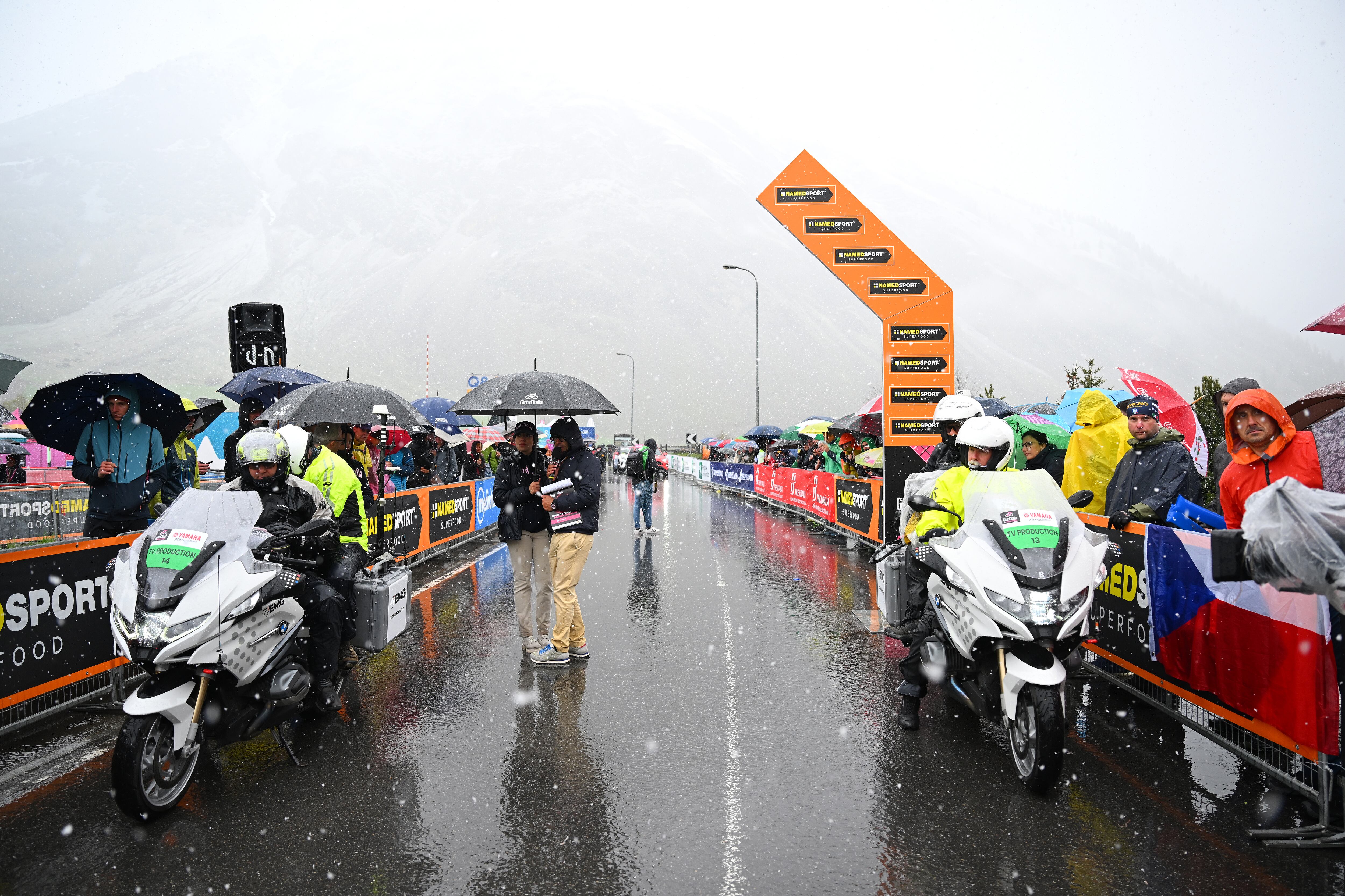 PRATO DI STELVIO, ITALY - MAY 21: TV motorbikes at start line in the rain and snow prior to the 107th Giro d'Italia 2024, Stage 16 a 206km stage from Prato di Stelvio to Santa Cristina Valgardena - Monte Pana 1625m / #UCIWT / on May 21, 2024 in Prato di Stelvio, Italy. (Photo by Tim de Waele/Getty Images)