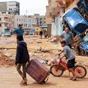 A boy pulls a suitcase past debris in a flash-flood damaged area in Derna, eastern Libya, on September 11, 2023. Flash floods in eastern Libya killed more than 2,300 people in the Mediterranean coastal city of Derna alone, the emergency services of the Tripoli-based government said on September 12. (Photo by AFP)