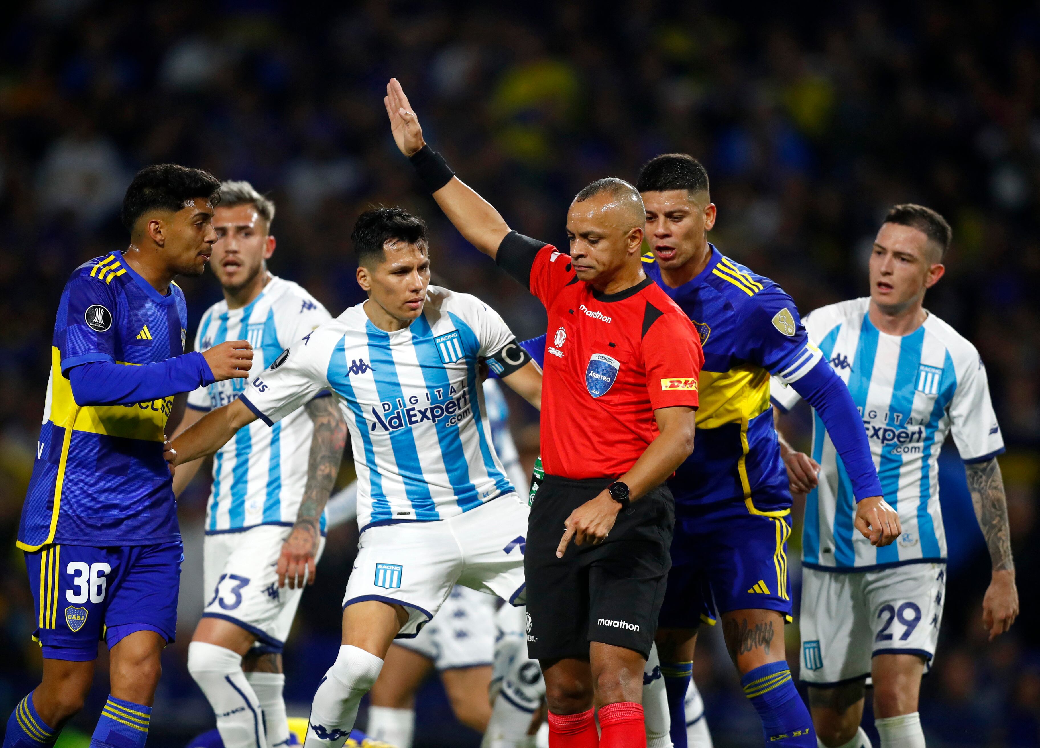 Soccer Football - Copa Libertadores - Quarter Finals - First Leg - Boca Juniors v Racing Club - Estadio La Bombonera, Buenos Aires, Argentina - August 23, 2023 Referee Wilton Sampaio with players during the match REUTERS/Agustin Marcarian