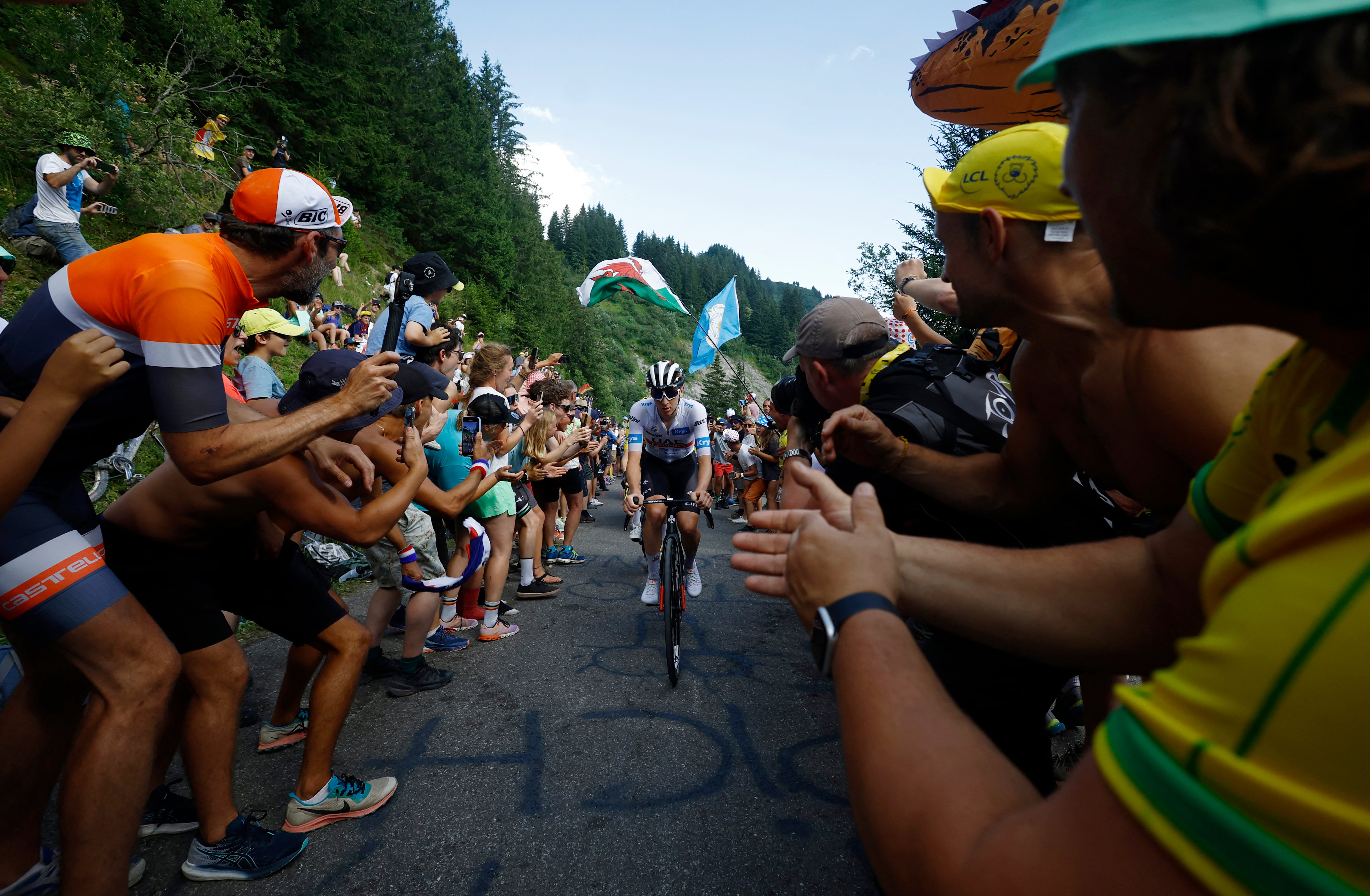 Cycling - Tour de France - Stage 14 - Annemasse to Morzine Les Portes Du Soleil - France - July 15, 2023 UAE Team Emirates' Tadej Pogacar in action during stage 14 as spectators cheer on REUTERS/Stephane Mahe