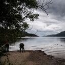 Los visitantes observan el agua del lago Ness, que está experimentando un nivel de agua inferior al promedio, el 6 de julio de 2023, en las Tierras Altas de Escocia.