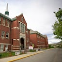 The former Kamloops Indian Residential School is seen on Tk'emlups te Secwépemc First Nation in Kamloops, British Columbia, Canada on Thursday, May 27, 2021. The remains of 215 children have been found buried on the site of the former residential school in Kamloops. (Andrew Snucins/The Canadian Press via AP)