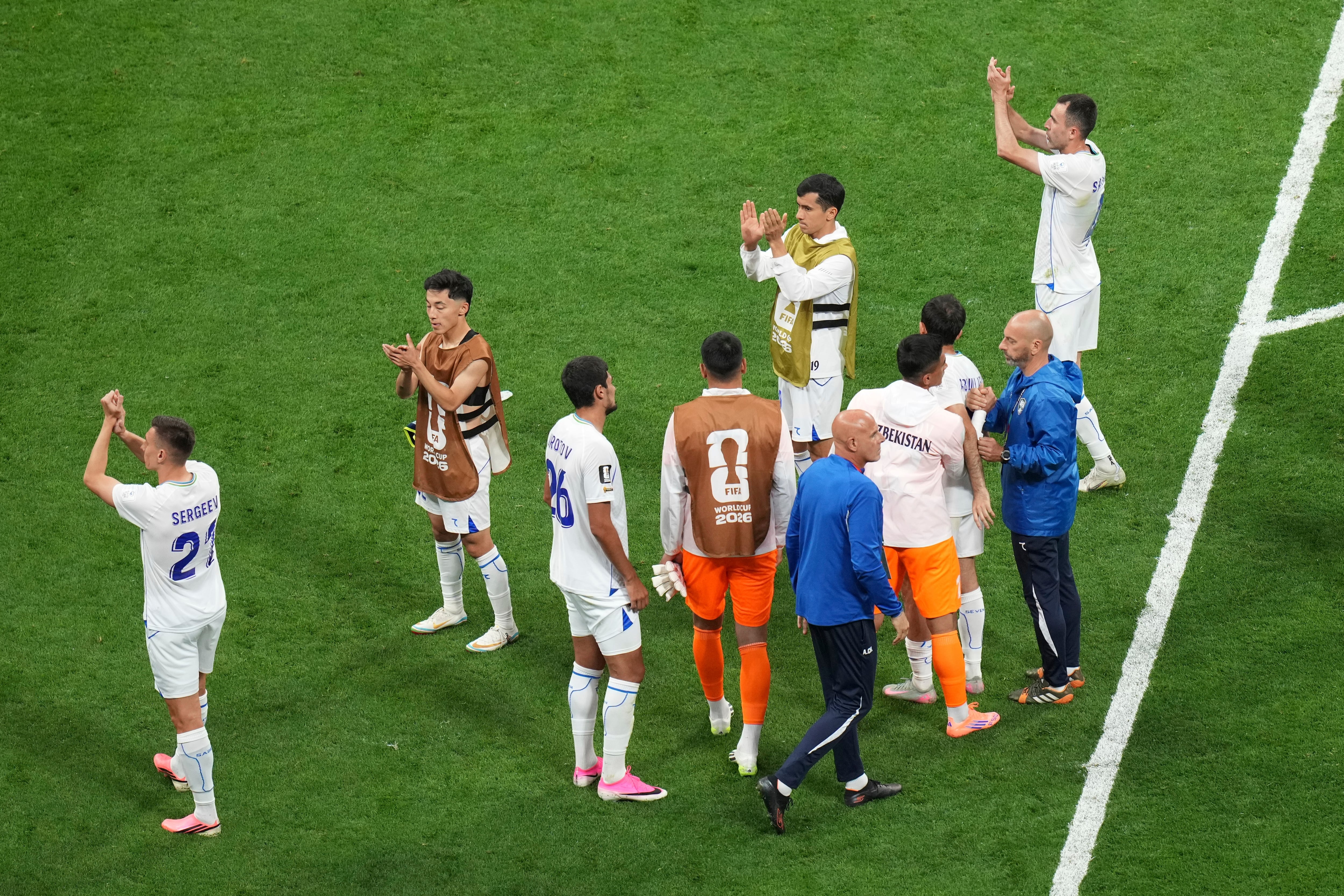 Uzbekistan's players applaud at the end of the match during the World Cup Group K soccer match between Uzbekistan and Colombia in Mexico City, Wednesday, June 17, 2026. (AP Photo/Silvia Izquierdo)