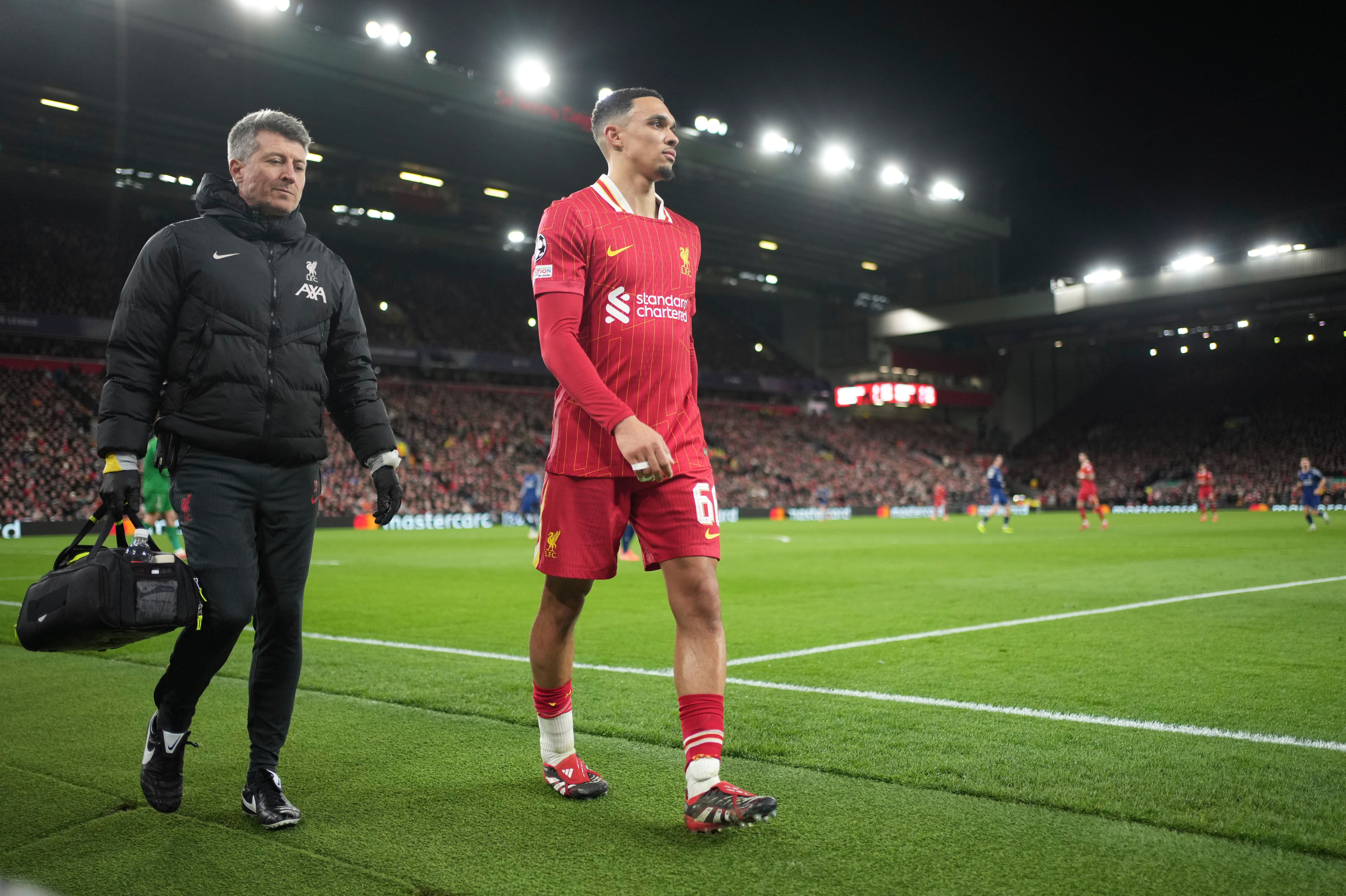 Liverpool's Trent Alexander-Arnold walks off injred during the Champions League round of 16 second leg soccer match between Liverpool and Paris Saint-Germain at Anfield in Liverpool, England, Tuesday, March 11, 2025. (AP Photo/Jon Super)
