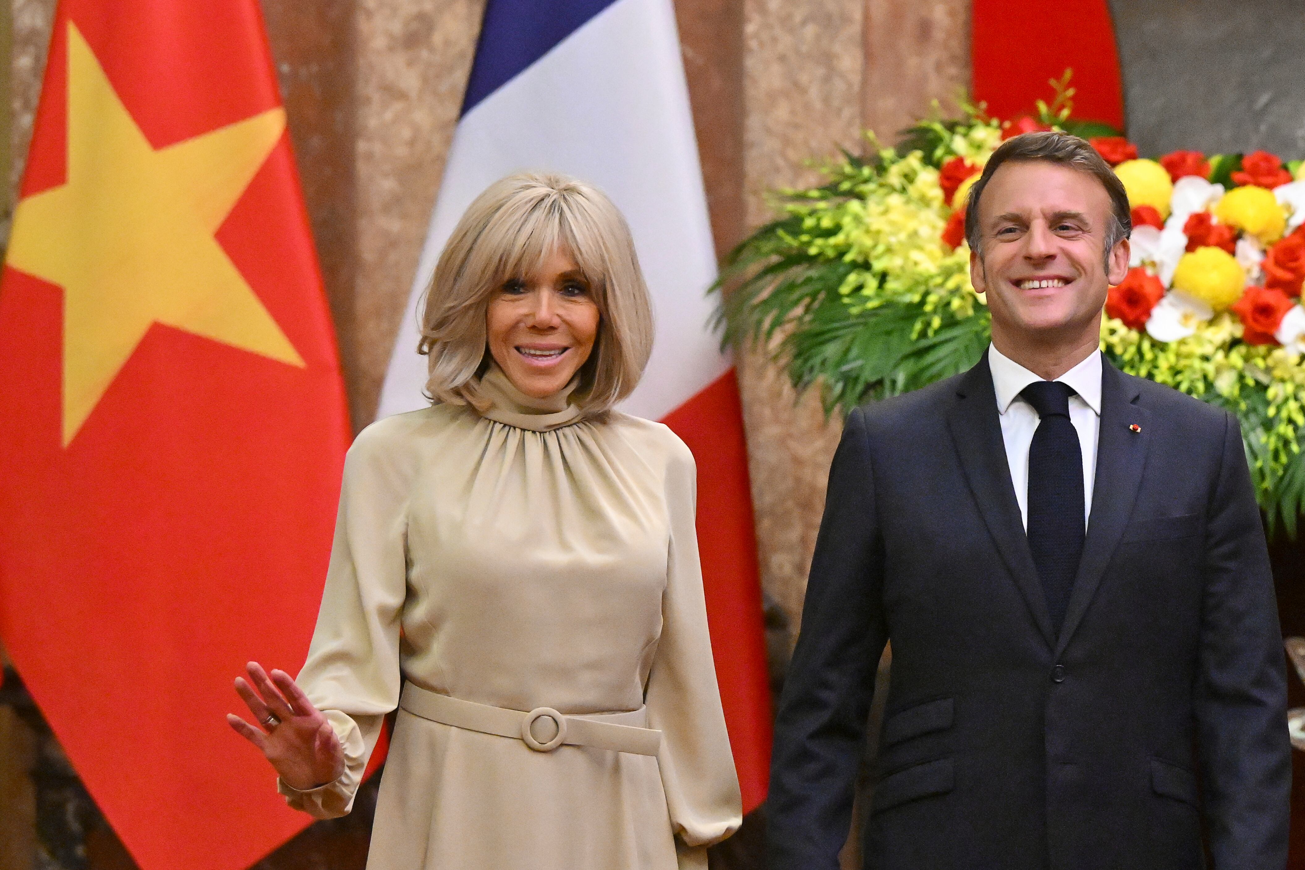 France's President Emmanuel Macron and his wife Brigitte Macron pose for photos at the Presidential Palace in Hanoi, Veitnam Monday, May 26, 2025. (Nhac Nguyen/Pool Photo via AP)