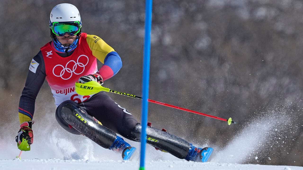Michael Poettoz, of Colombia passes a gate during the first run of the men's slalom at the 2022 Winter Olympics, Wednesday, Feb. 16, 2022, in the Yanqing district of Beijing. (AP Photo/Robert F. Bukaty)