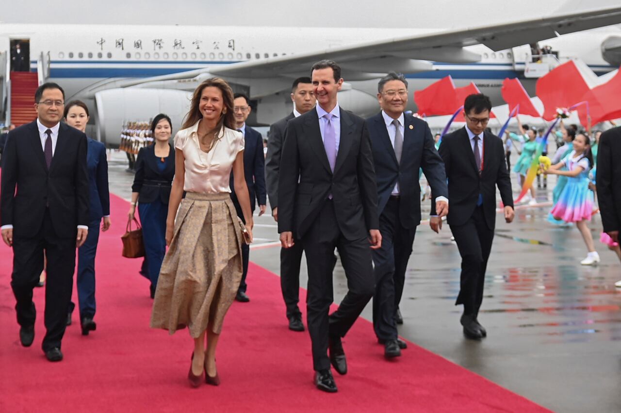 En esta fotografía publicada por la agencia de noticias Xinhua, el presidente sirio Bashar Assad, centro derecha, y la primera dama Asma Assad llegan a Hangzhou, China, el 21 de septiembre de 2023.