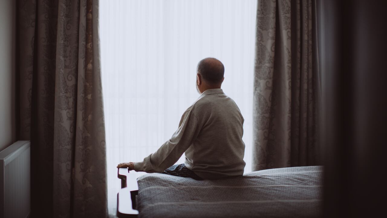 Growing old isn't for sissies. Shot of a depressed senior man sitting on his bed at home