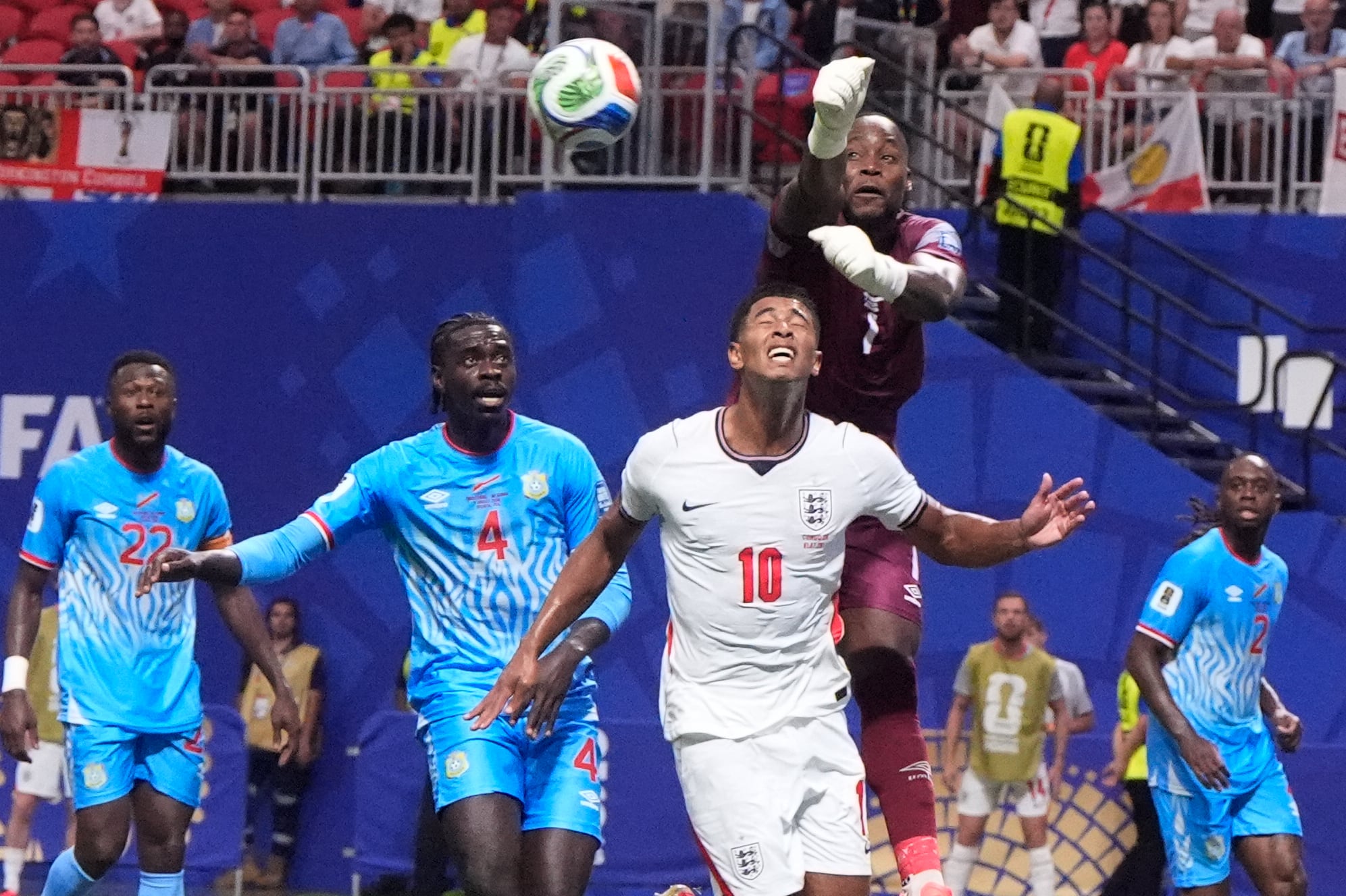 Congo goalkeeper Lionel Mpasi makes a save over England's Jude Bellingham during a World Cup round of 32 soccer match in Atlanta, Wednesday, July 1, 2026. (AP Photo/Mike Stewart)
