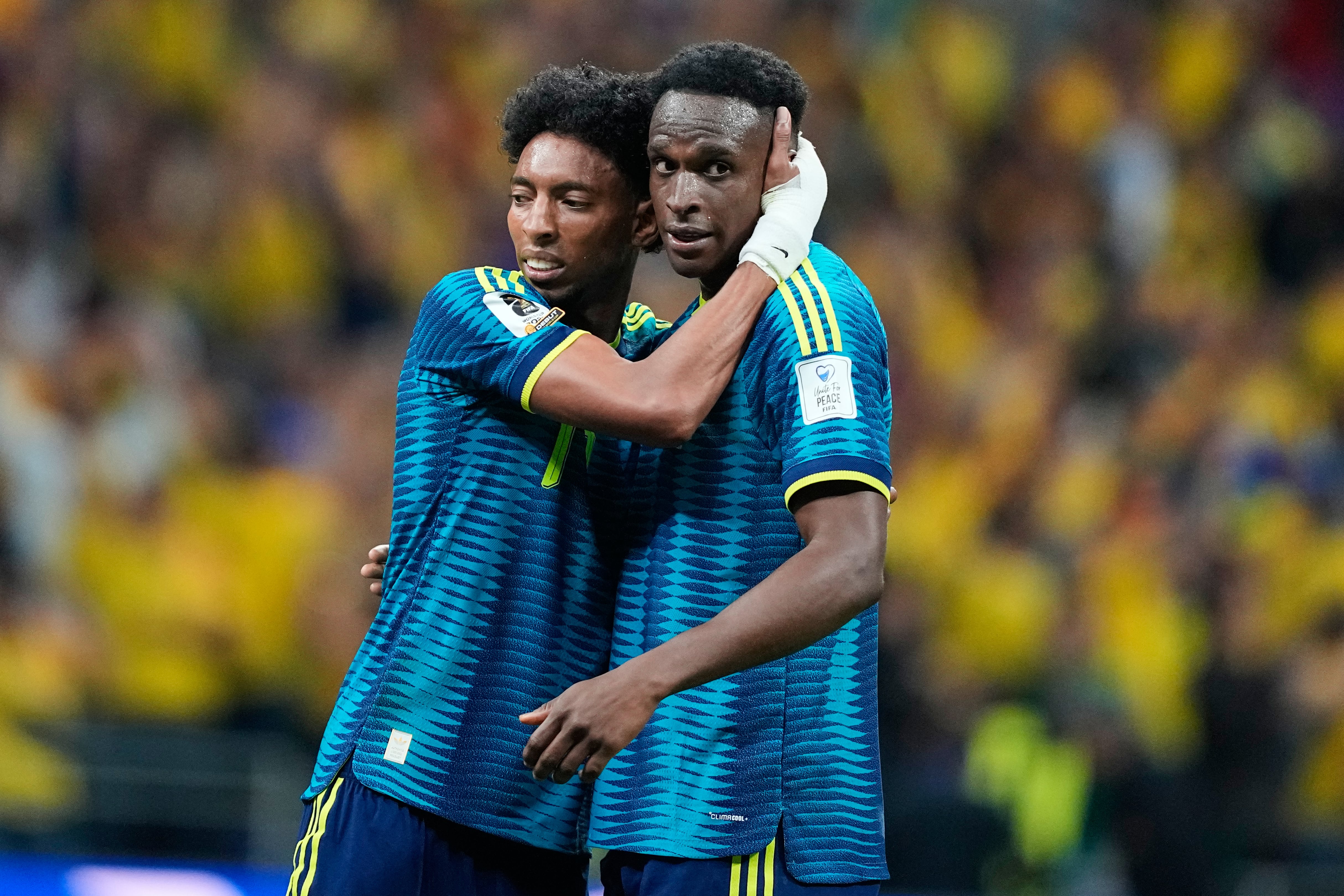 Colombia's Johan Mojica and Jhon Lucumi, right, embrace following the World Cup Group K soccer match between Uzbekistan and Colombia in Mexico City, Wednesday, June 17, 2026. (AP Photo/Natacha Pisarenko)