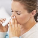 Woman using nasal drops