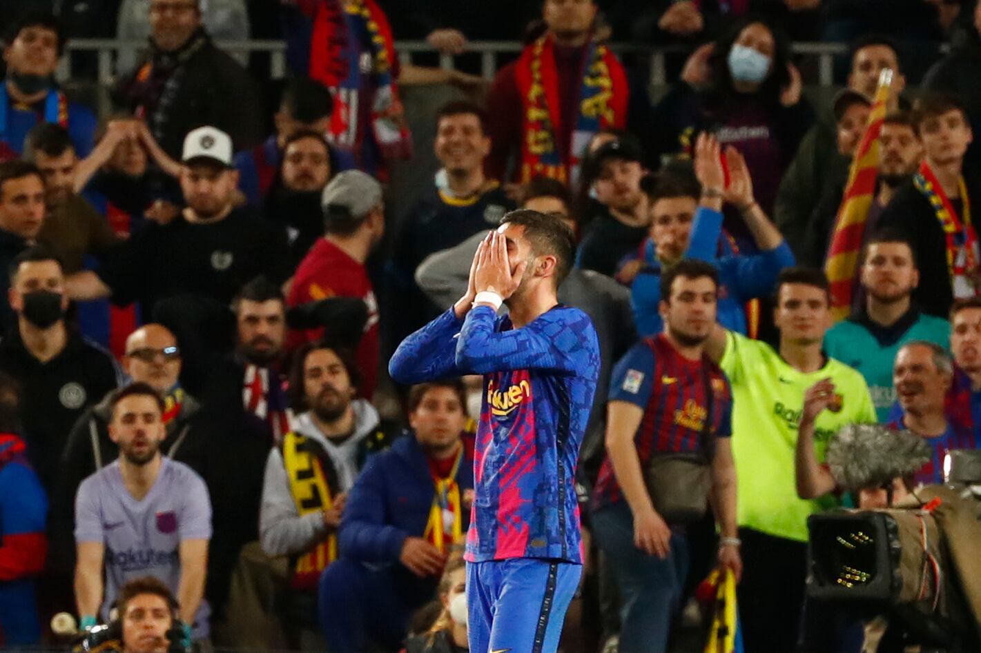 Barcelona's Ferran Torres covers his face after missing a scoring chance during the Europa League soccer match between Barcelona and Napoli in Barcelona, Spain, Thursday, Feb. 17, 2022. (AP Photo/Joan Monfort)