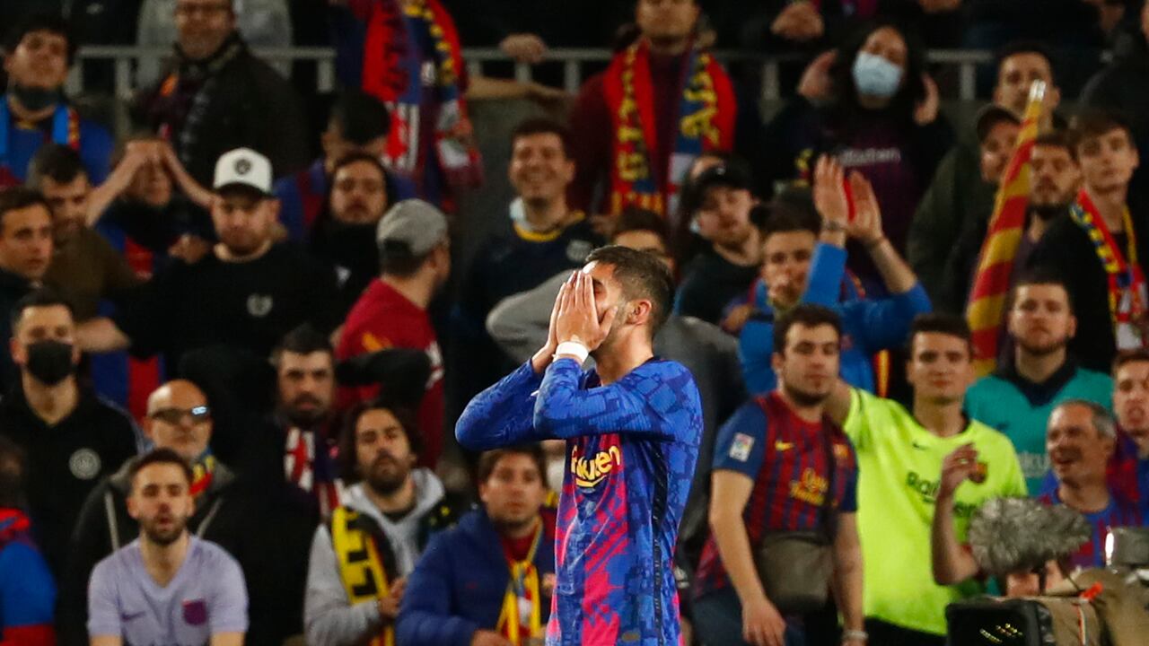 Barcelona's Ferran Torres covers his face after missing a scoring chance during the Europa League soccer match between Barcelona and Napoli in Barcelona, Spain, Thursday, Feb. 17, 2022. (AP Photo/Joan Monfort)