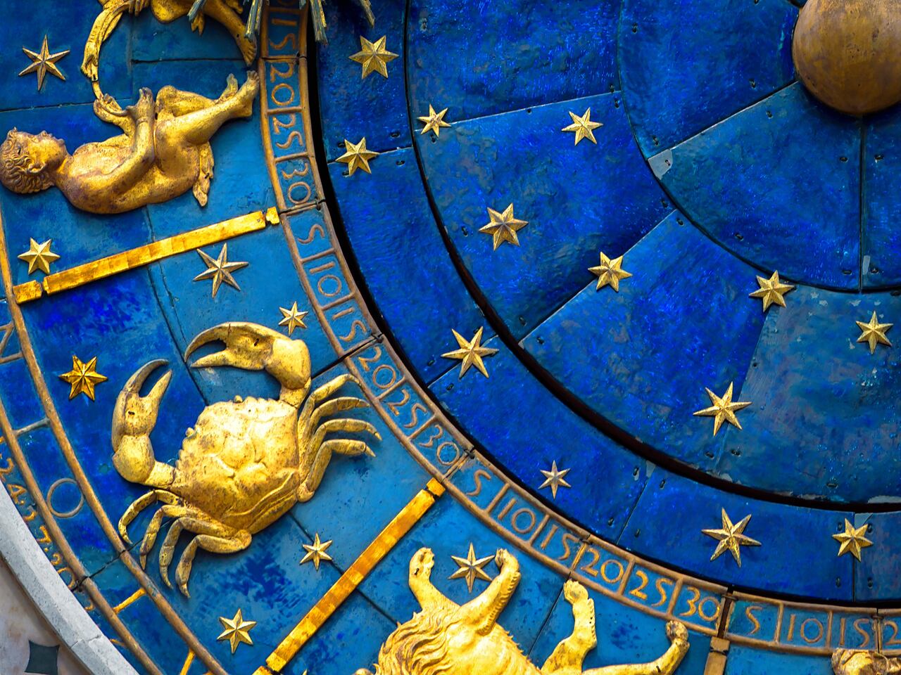 Cancer astrological sign on ancient clock, medieval Torre dell’Orologio in Venice. Detail of Zodiac wheel with crab. Golden symbol of Cancer on star circle closeup. Concept of astrology and horoscope.
