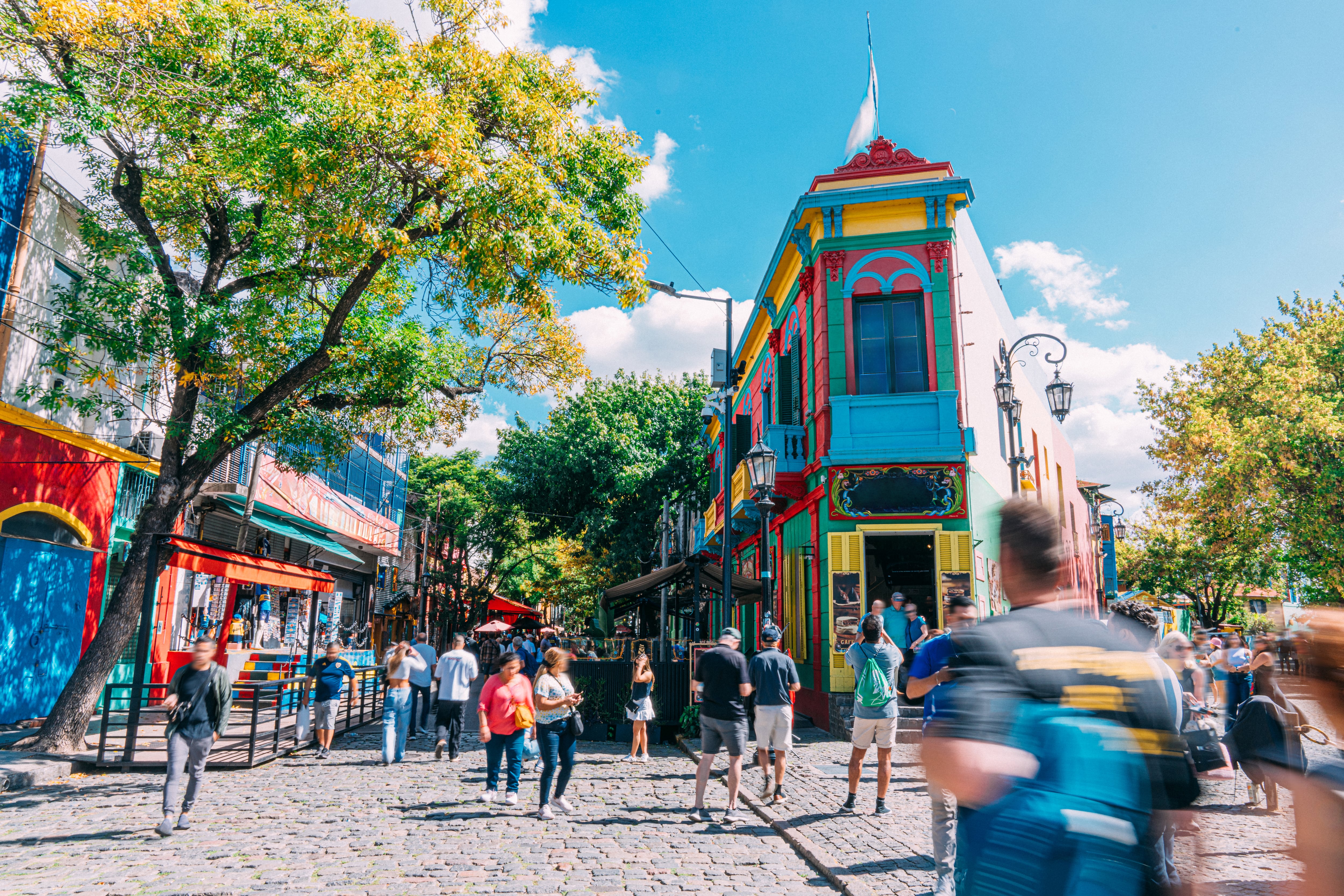 A Wide Angle View of Tourists visiting the Vibrant-Colored Houses and Businesses in La Boca, Buenos Aires, Argentina.
Many ship-building residents built homes from leftover ship materials and paint, creating mismatched textures and patchwork style.