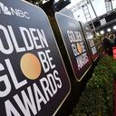 FILE - Event signage appears above the red carpet at the 77th annual Golden Globe Awards, on Jan. 5, 2020, in Beverly Hills, Calif. The 78th annual Golden Globes will be held on Sunday, Feb. 18, 2021. (Photo by Jordan Strauss/Invision/AP, File)