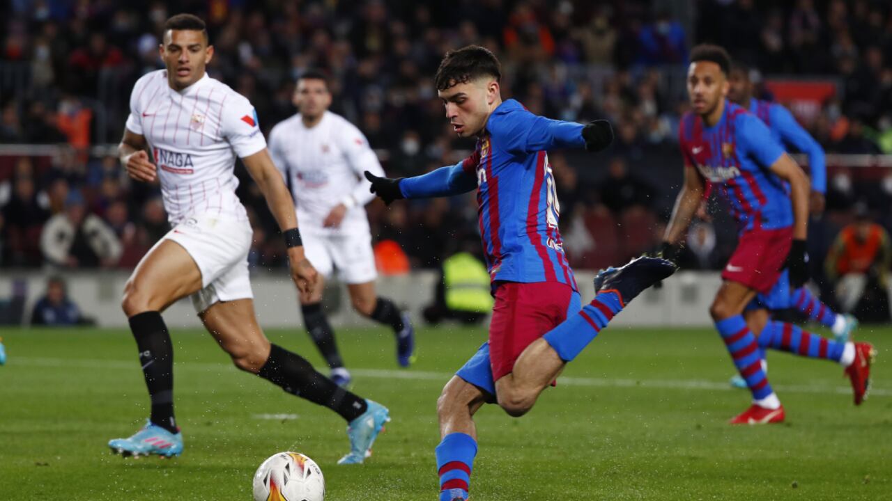 Barcelona's Pedri, center, shots on target during the Spanish La Liga soccer match between FC Barcelona and Sevilla at the Camp Nou stadium in Barcelona, Spain, Sunday, April 3, 2022. (AP/Joan Monfort)