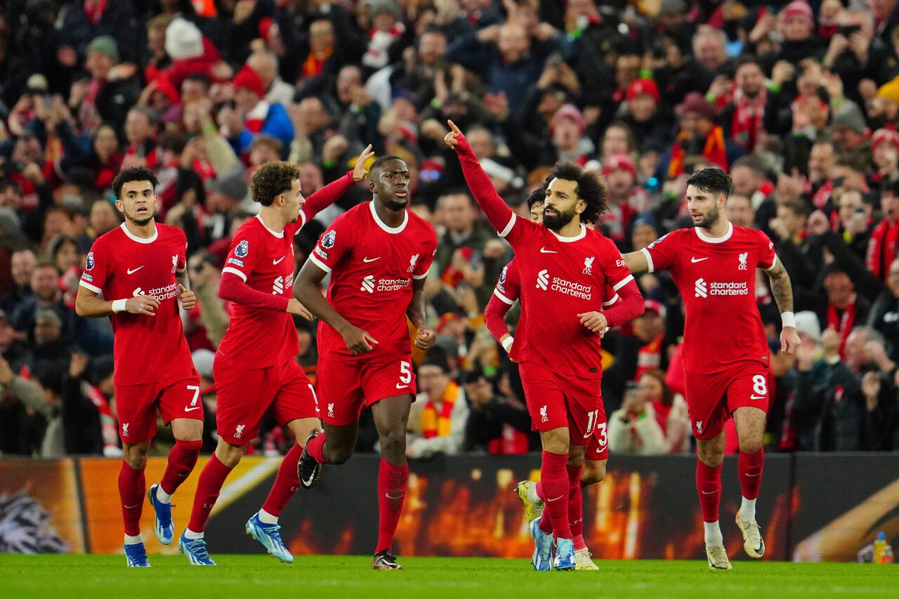 Liverpool's Mohamed Salah, second right, celebrates after scoring his side's opening goal during the English Premier League soccer match between Liverpool and Arsenal at Anfield stadium in Liverpool, England, Saturday, Dec. 23, 2023. (AP Photo/Jon Super)