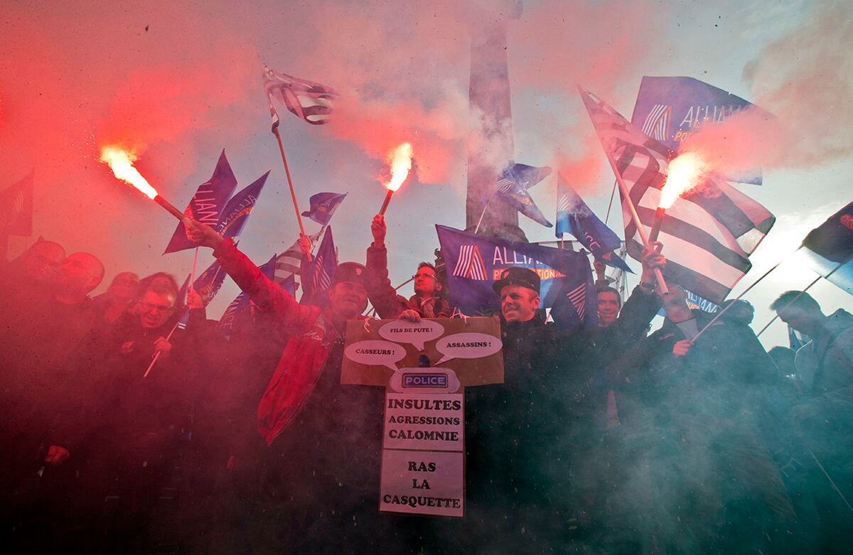 En París, oficiales de policía protestan por mejores condiciones de trabajo. Mientras los gremios de uniformados marchaban por la ciudad, cientos de estudiantes bloquearon la entrada a diferentes escuelas de la ciudad, en protesta por la brutalidad policíaca. El cartel lee: “Insultos, agresiones, calumnias: hasta la coronilla”. (AP)