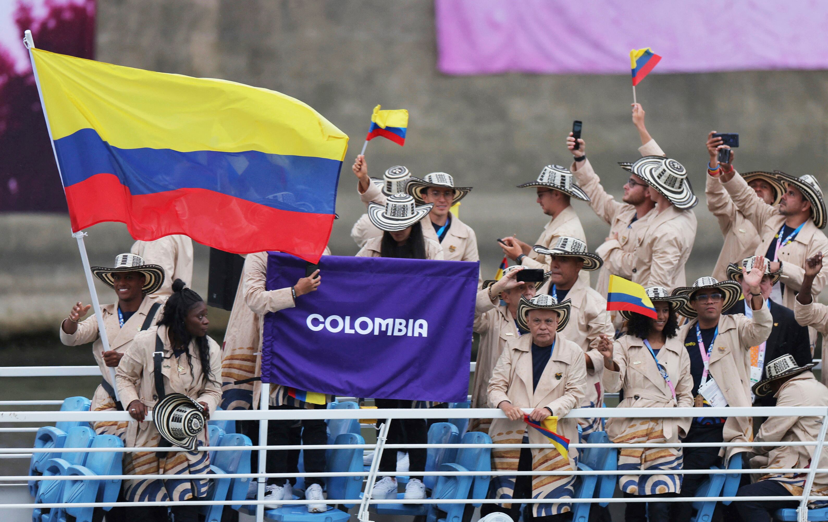 Athletes of Colombia aboard a boat as it makes its way along the Seine in Paris, France, during the opening ceremony for the 2024 Summer Olympics, Friday, July 26, 2024. (Ann Wang/Pool Photo via AP)