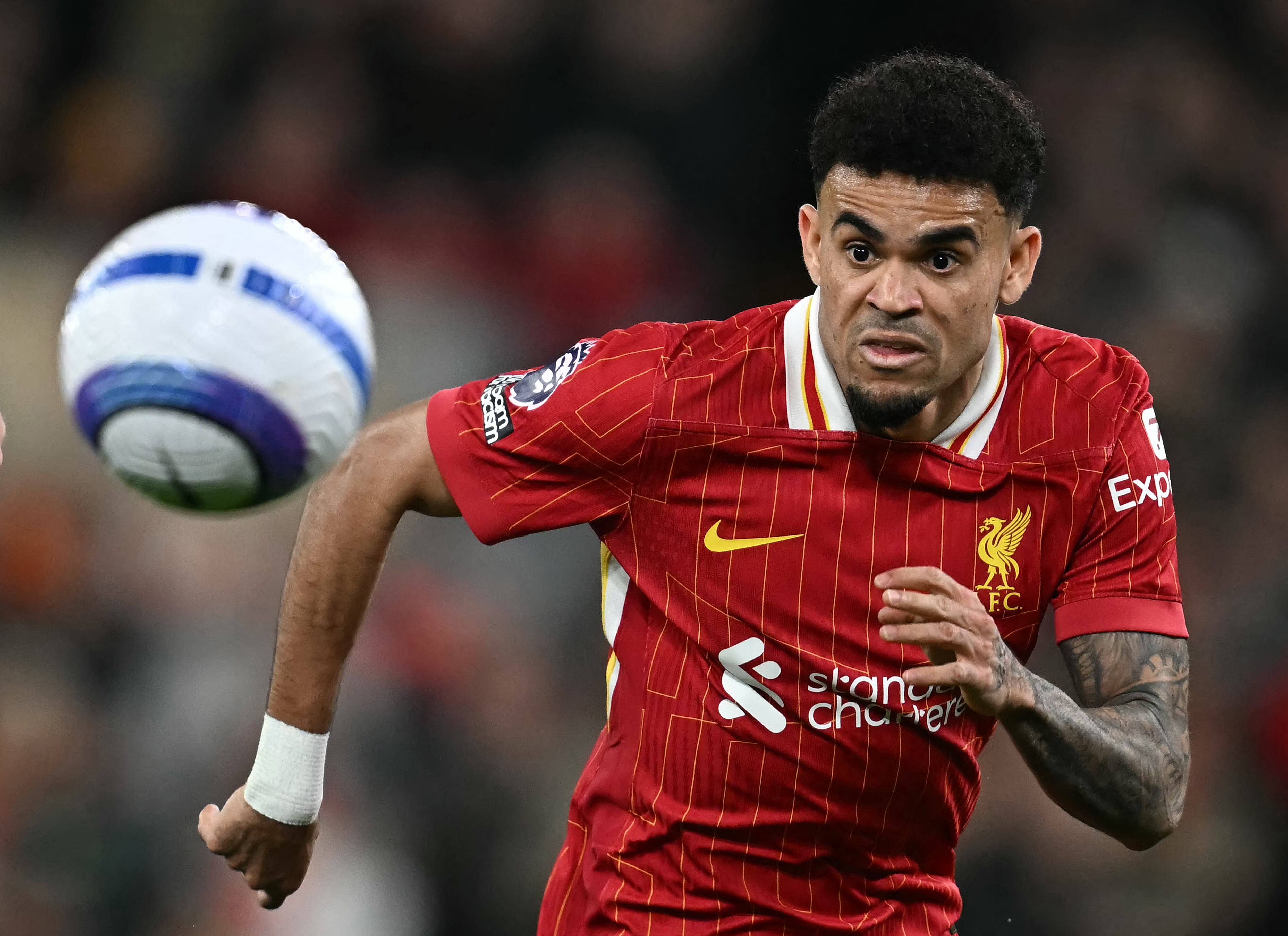 Liverpool's Colombian midfielder #07 Luis Diaz chases down the ball during the English Premier League football match between Liverpool and Everton at Anfield in Liverpool, north west England on April 2, 2025. (Photo by Paul ELLIS / AFP) / RESTRICTED TO EDITORIAL USE. No use with unauthorized audio, video, data, fixture lists, club/league logos or 'live' services. Online in-match use limited to 120 images. An additional 40 images may be used in extra time. No video emulation. Social media in-match use limited to 120 images. An additional 40 images may be used in extra time. No use in betting publications, games or single club/league/player publications. /