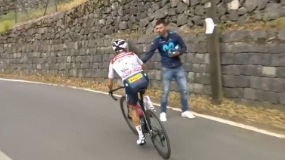 Momento en el que Iván Velasco, jefe de filas del Movistar, le da un termo a Juanpe López del Trek