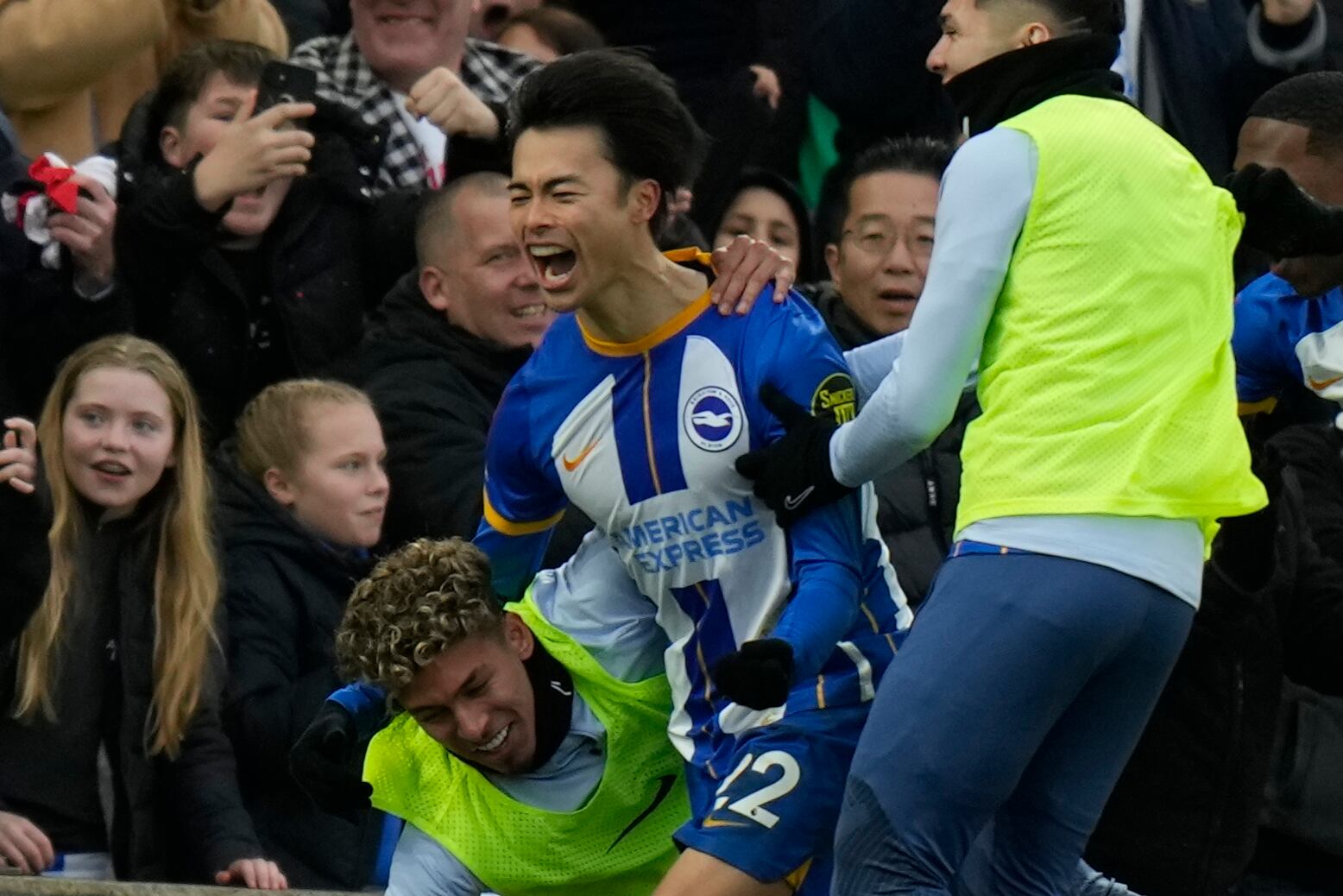 Brighton's Kaoru Mitoma, left, celebrates after scoring his side's second goal during the FA Cup 4th round soccer match between Brighton and Hove Albion and Liverpool at the Falmer Stadium in Brighton, England, Sunday, Jan. 29, 2023. (AP Photo/Alastair Grant)