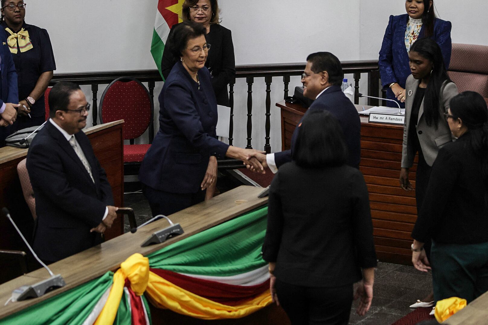 La líder de la oposición de Surinam, Jennifer Geerlings-Simons, estrecha la mano del presidente saliente, Chan Santokhi, tras las elecciones a la Asamblea Nacional en Paramaribo el 6 de julio de 2025.