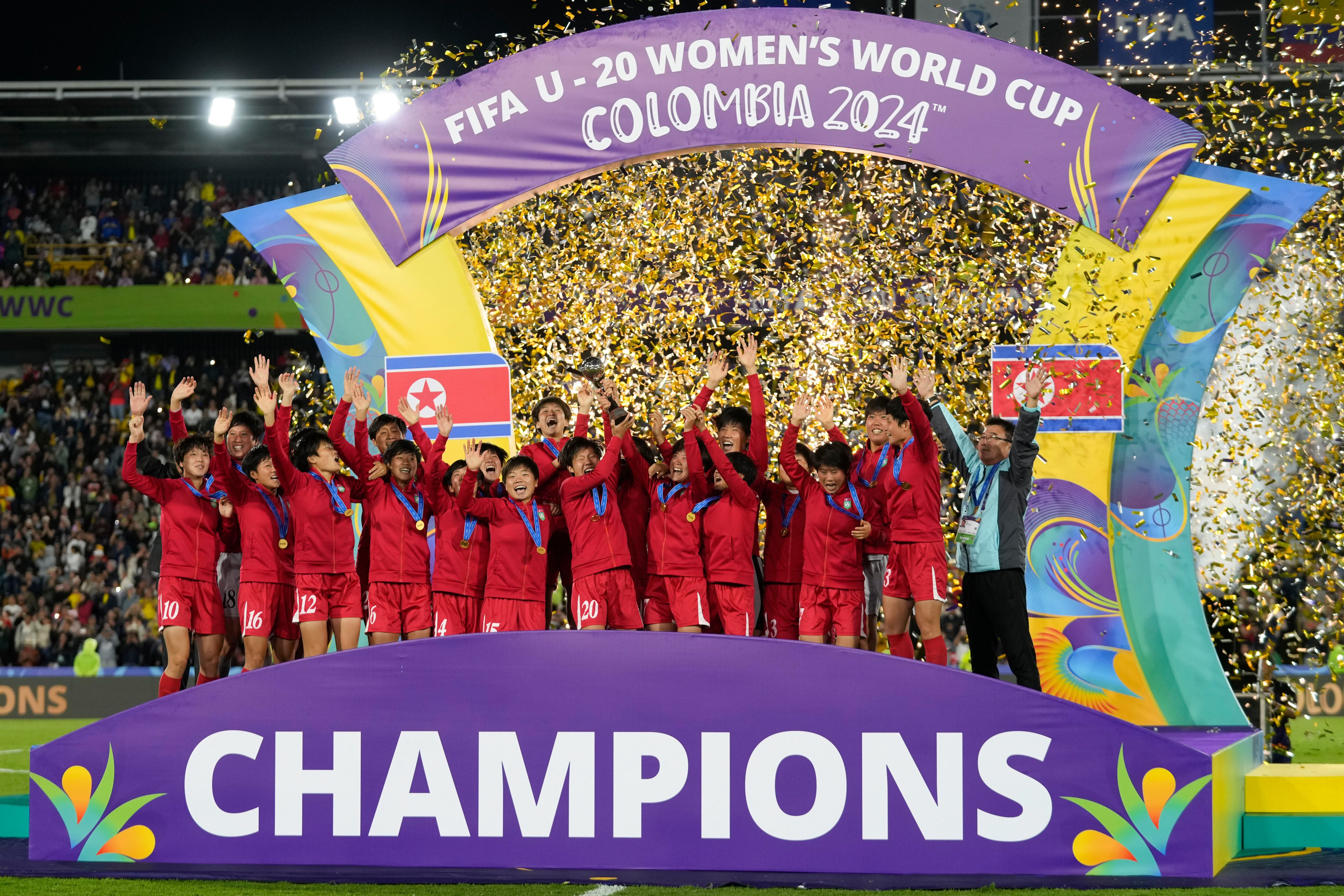 North Korean players celebrate with the trophy after winning the U-20 Women's World Cup final soccer match against Japan at El Campin stadium in Bogota, Colombia, Sunday, Sept. 22, 2024.(AP Photo/Fernando Vergara)